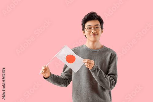 Young Asian man with flag o...