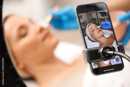 Cosmetologist applying mask...