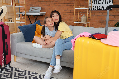 Mother and daughter embraci...