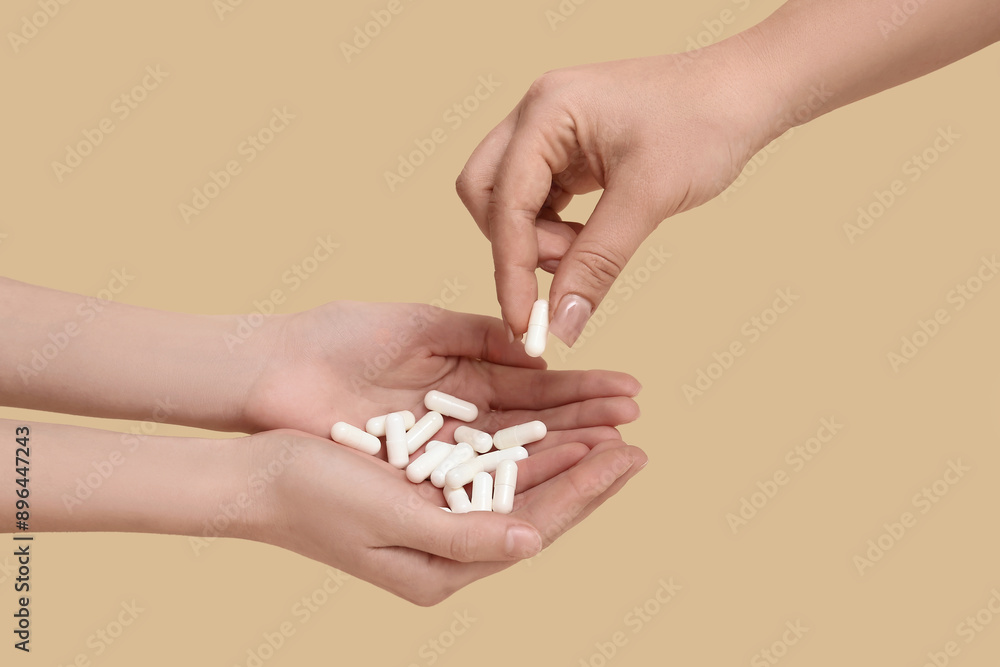 Female hands with pills on beige background Female hands with pills on beige background