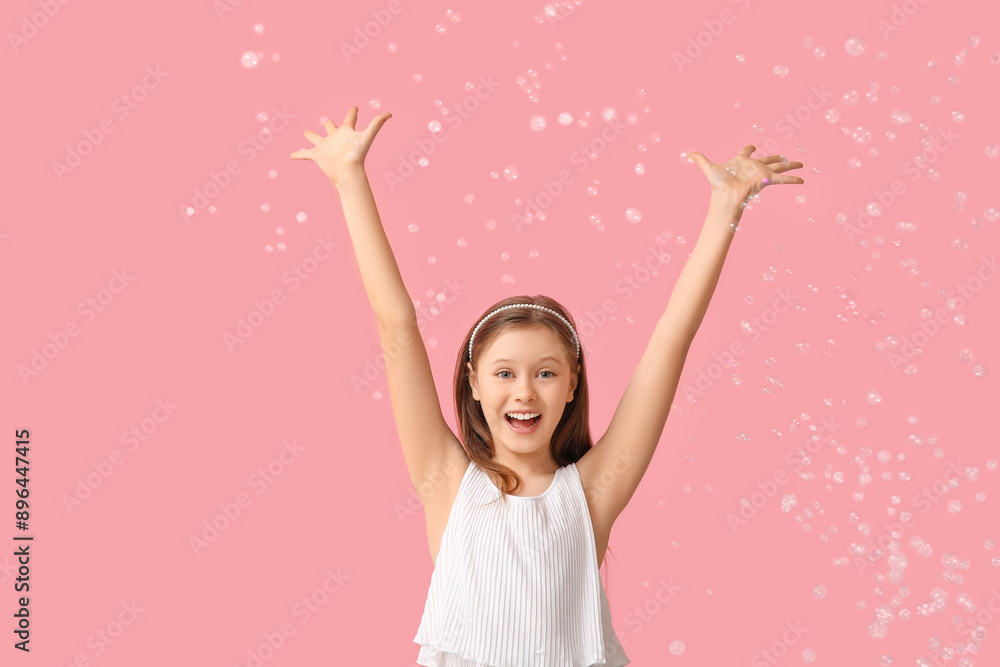 Happy girl with soap bubbles on pink background Happy girl with soap bubbles on pink background
