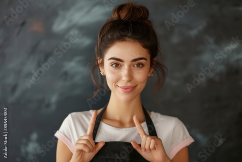 Aproned woman gesturing at torso Mockup for bakery profession photo