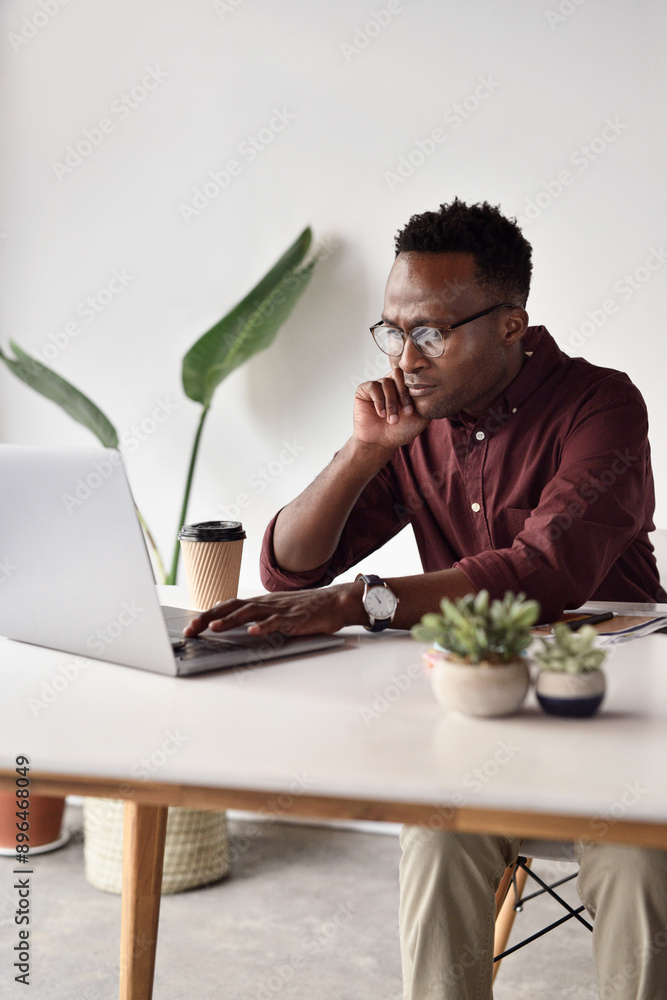 Idea, black man and laptop in office for research, email and connection for networking. Business, technology and website developer at desk for career, project and thinking or creativity for proposal Idea, black man and laptop in office for research, email and connection for networking. Business, technology and website developer at desk for career, project and thinking or creativity for proposal