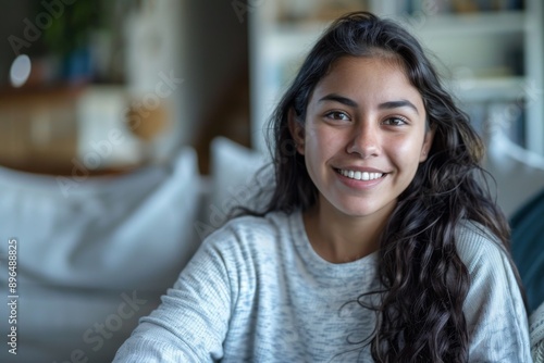 Free Download Portrait of a smiling young Hispanic woman at home - GFXLoad