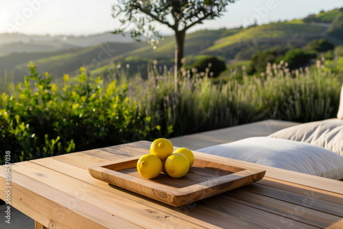 Lounge area with modern furniture, ripe lemons in the wooden plane on the tanle and views of the green hills photo