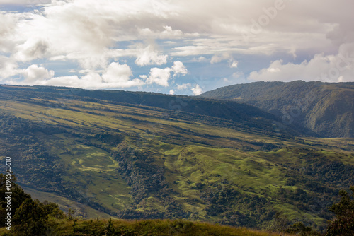 The magnificent landscape of the eastern Andean mountains of central Colombia, illuminated by the light of sunset on an overcast sky.