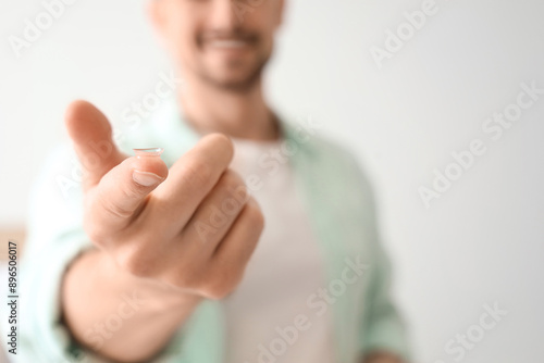 Young man with contact lens...
