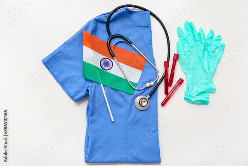 Test tubes, stethoscope, doctor's uniform and flag of India on white background. National Doctor's Day celebration photo