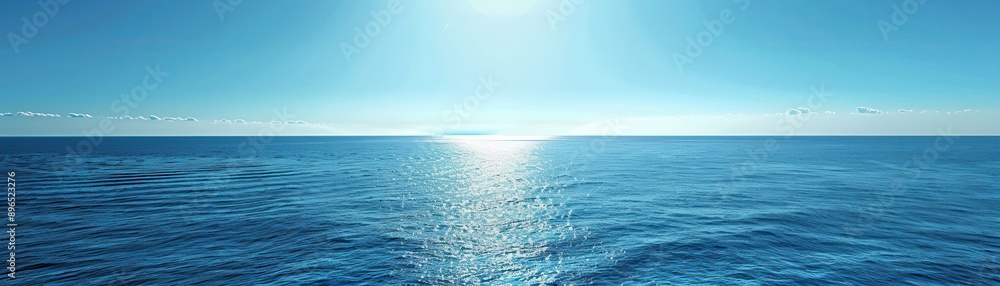 Fototapeta premium The ocean is calm and the sun is shining on the water