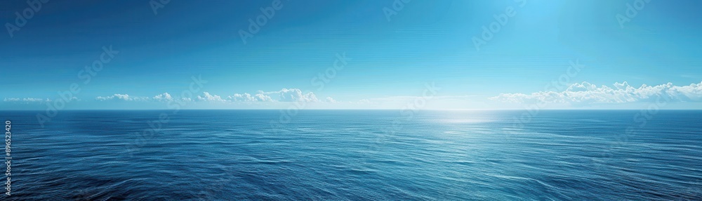 The ocean is calm and blue, with a clear sky above The ocean is calm and blue, with a clear sky above