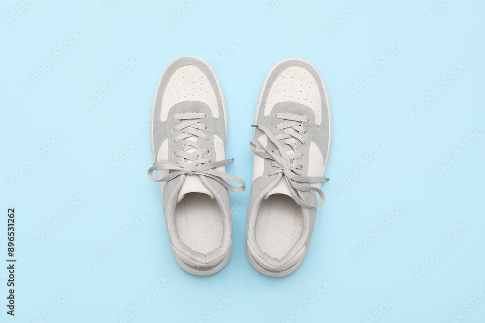 Stylish male sneakers on blue background Stylish male sneakers on blue background