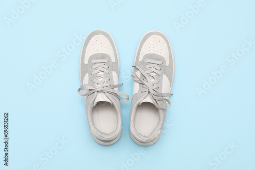 Wallpaper Mural Stylish male sneakers on blue background Torontodigital.ca