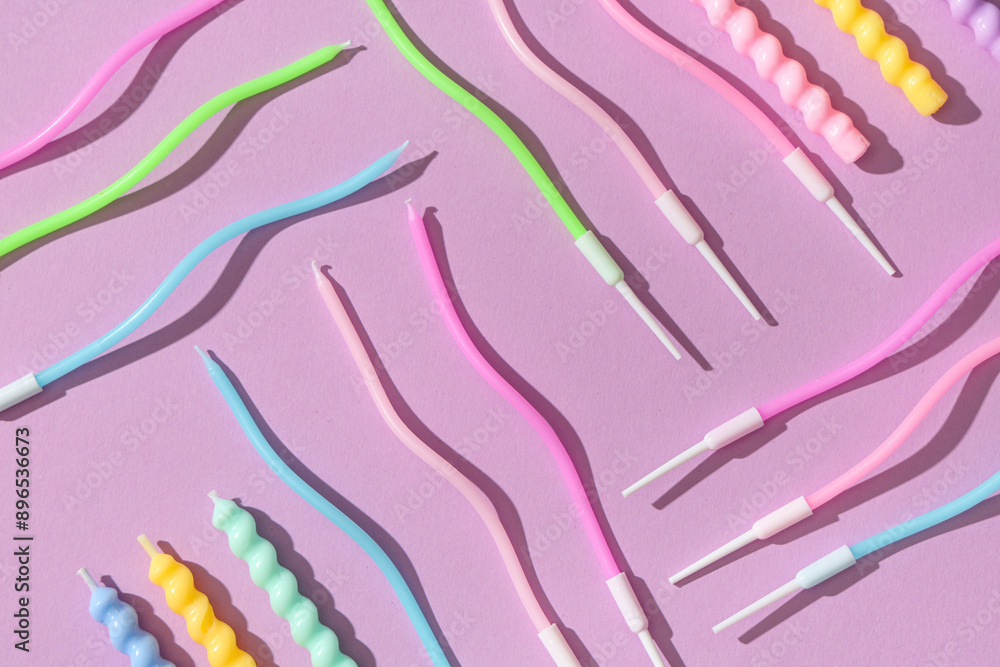 Naklejka premium Many colorful Birthday candles on lilac background