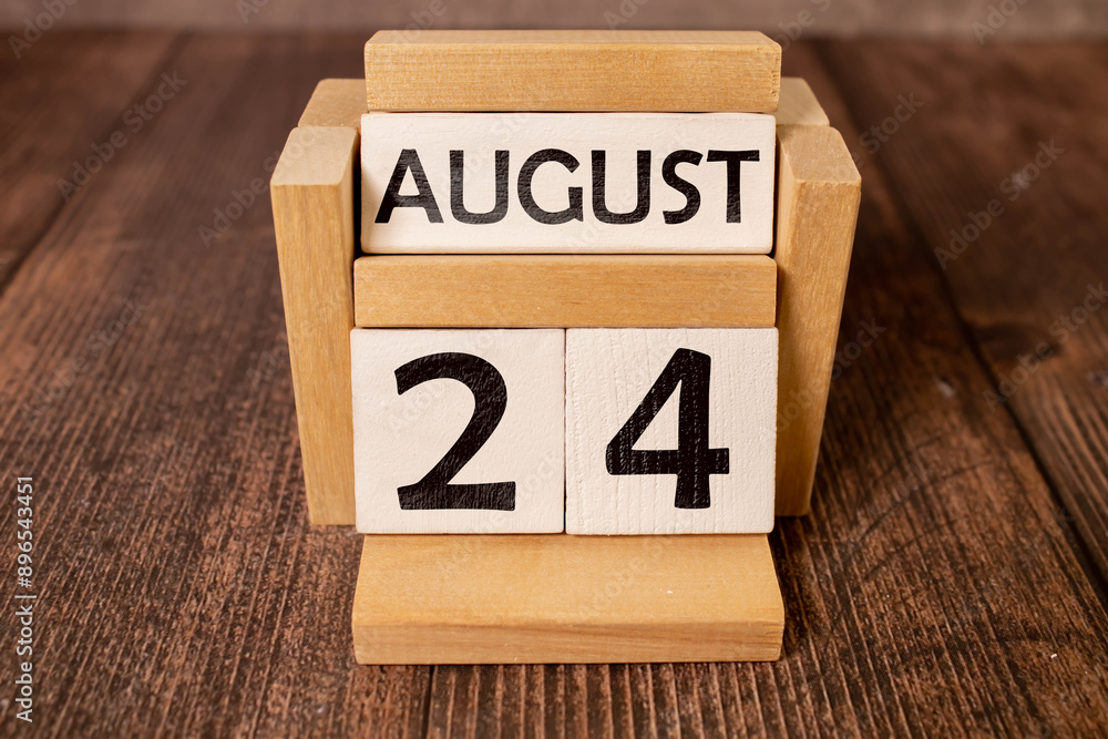 August 24 calendar date text on wooden blocks with blurred background park. Calendar concept. August 24 calendar date text on wooden blocks with blurred background park. Calendar concept.