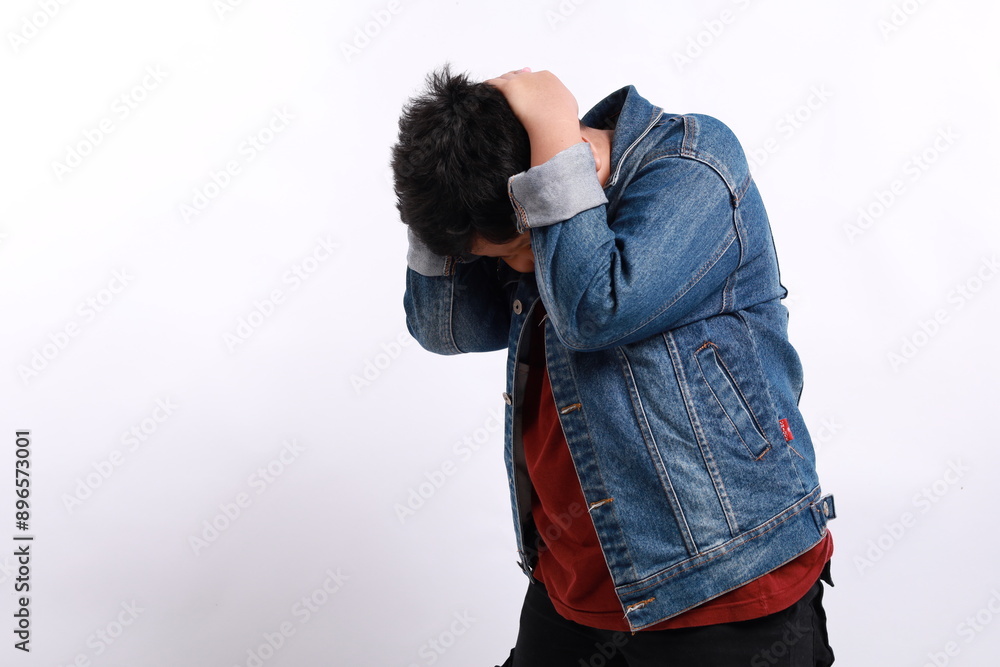 Portrait of asian little boy standing and holding his head. difficulties, failure or mistake concept. indoor studio shot, isolated on white background copyspace. Portrait of asian little boy standing and holding his head. difficulties, failure or mistake concept. indoor studio shot, isolated on white background copyspace.