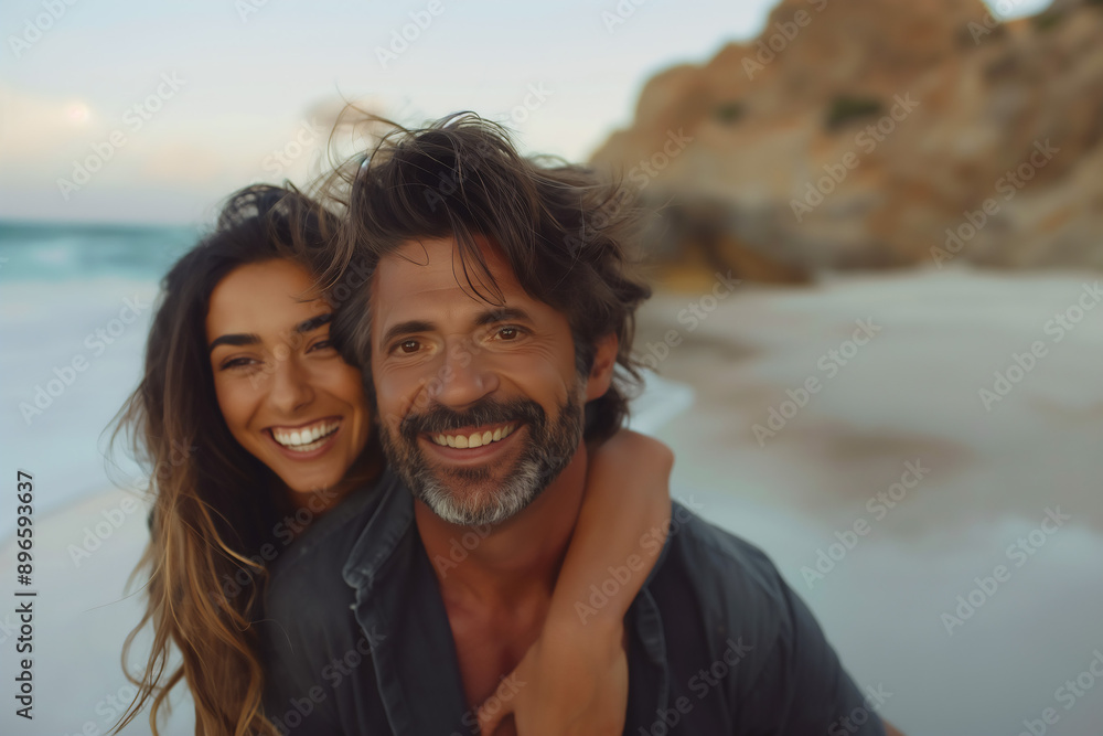 Obraz premium Portrait of middle age Caucasian couple on the beach on a Summer evening, copy space