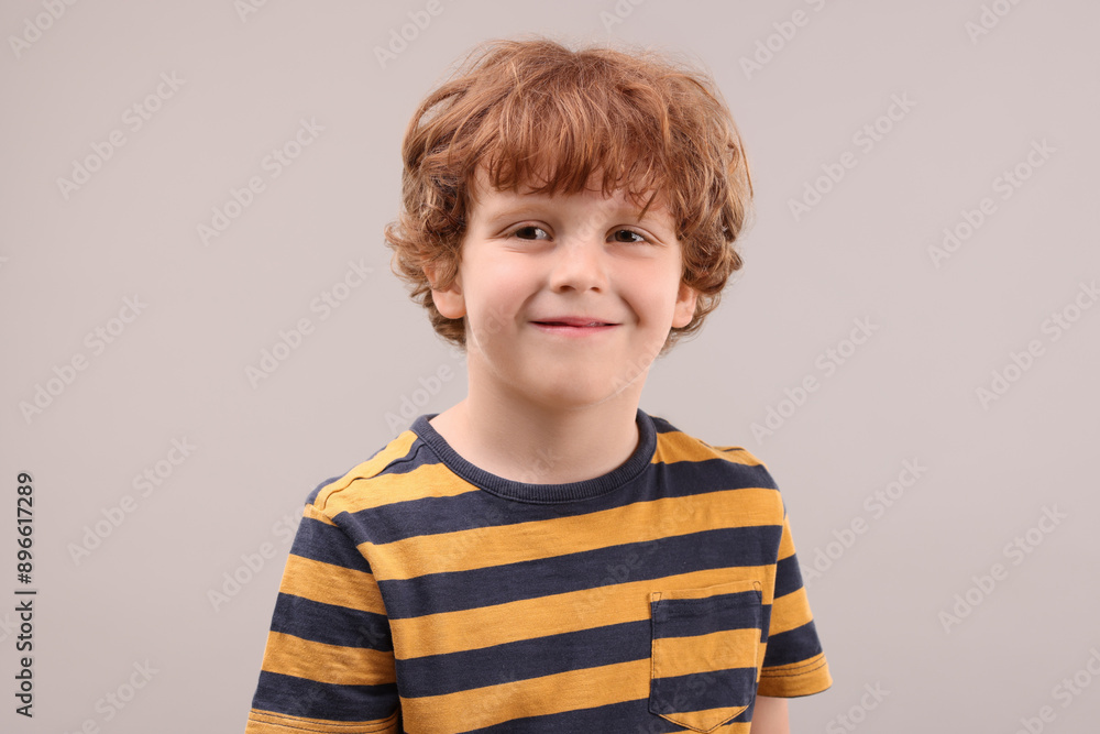 Portrait of cute little boy on grey background Portrait of cute little boy on grey background