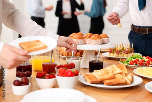 Coworkers having business lunch in restaurant, closeup © New Africa