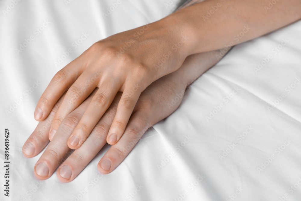 Lovely couple holding hands in bed, closeup Lovely couple holding hands in bed, closeup