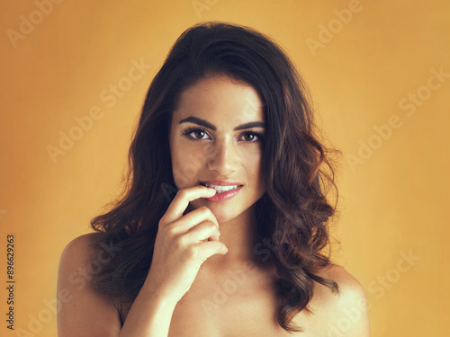 Fotografie Portrait, woman and seductive in yellow background with bare shoulders, skin and suggestive hand gesture
