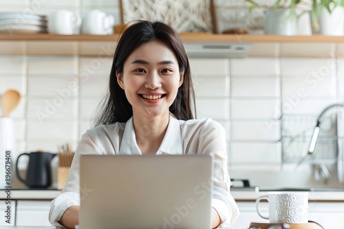 Happy young woman working remotely  photo