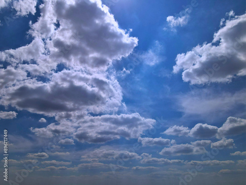 Blue Sky with Large White Clouds Partially Shaded from Below