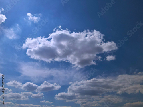 Blue Sky with Large White Clouds Partially Shaded from Below