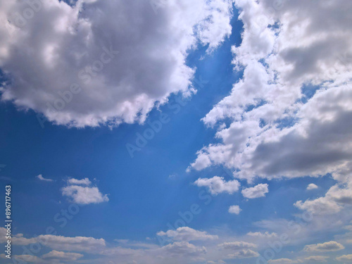 Blue Sky with Large White Clouds Partially Shaded from Below