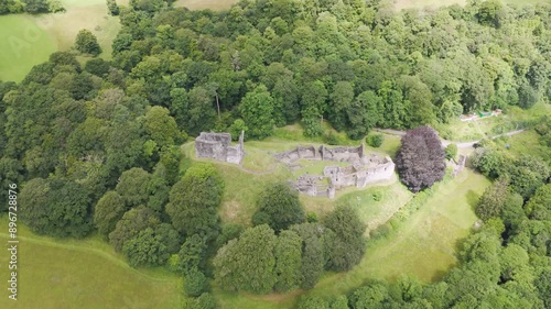 Drone orbital of Okehampton Castle amidst dense greenery in Devon, UK photo