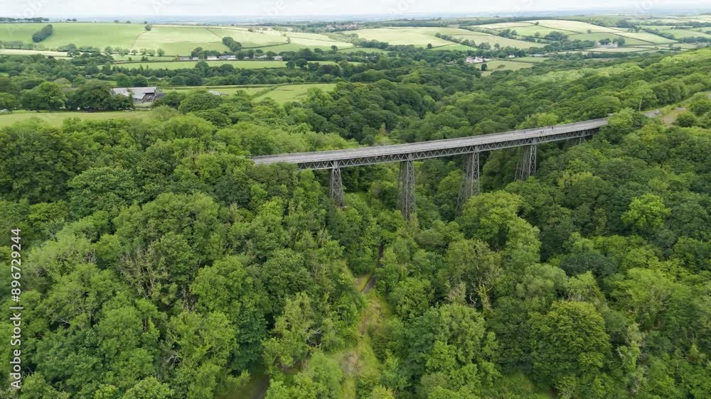 Aerial view of holiday tourists crossing over the Meldon Viaduct enjoying the scenic landscape of Devon, England Aerial view of holiday tourists crossing over the Meldon Viaduct enjoying the scenic landscape of Devon, England