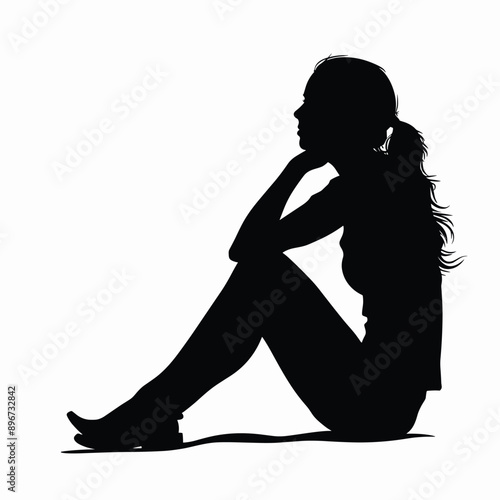 Silhouette of a woman sitting in a thoughtful pose.