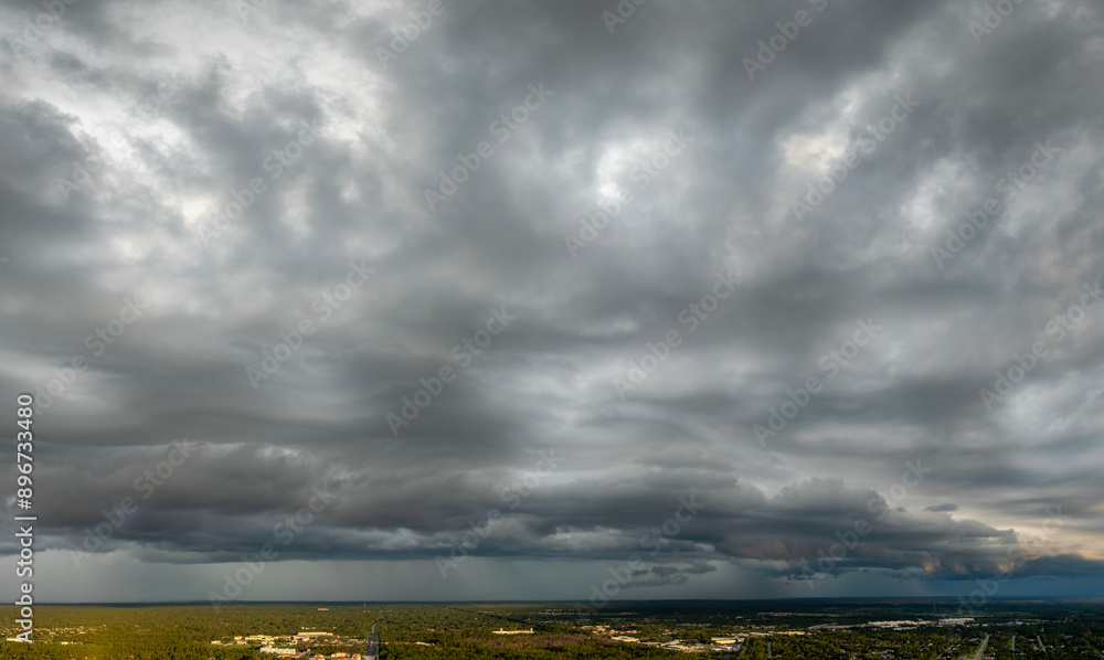 Obraz premium Heavy rain falling down from stormy clouds during thunderstorm on dark sky. Moving and changing cloudscape weather