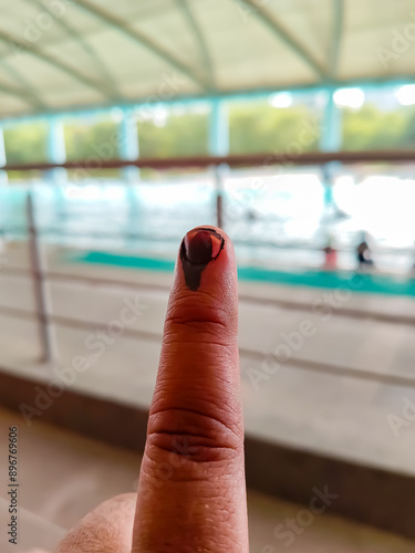 Young voter showing her ink-marked fingers after casting votes near polling booth of east Delhi, India for general Lok Sabha Elections 2024 photo