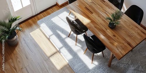 The elegant wooden dining table and black velvet chairs are set on a white rug, enhancing the contemporary ambiance of the modern-style interior.