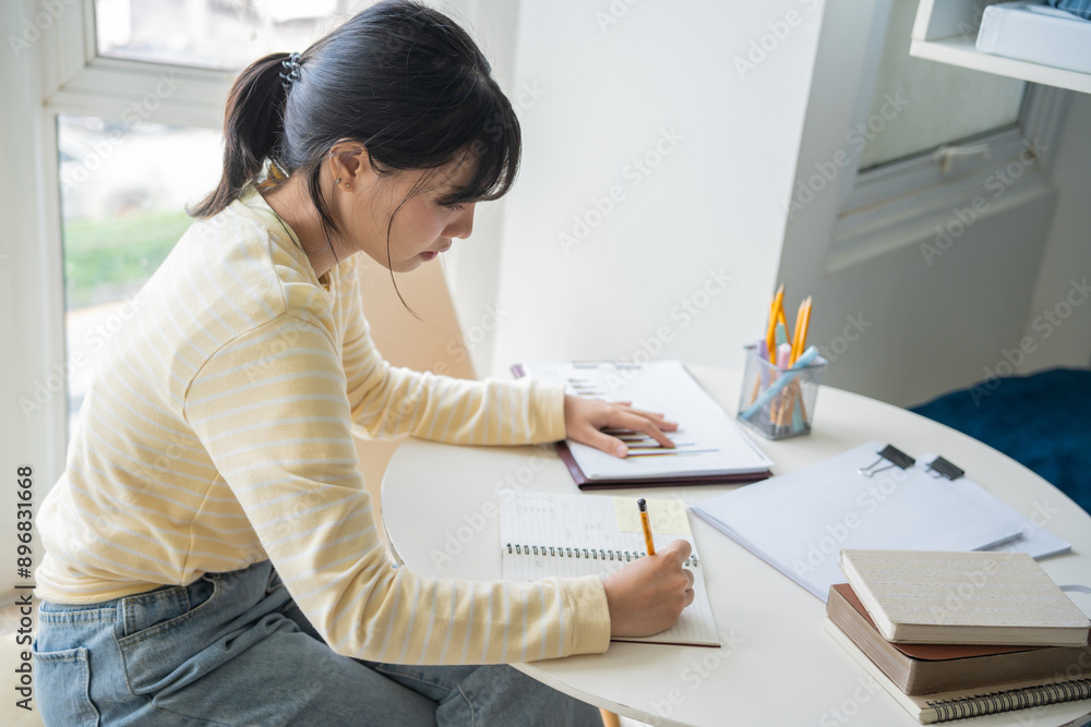 Student asian woman reading book in dorm room college student do homework in university dormitory Student asian woman reading book in dorm room college student do homework in university dormitory