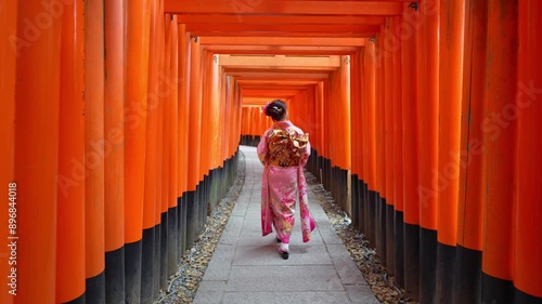 4k Slow motion video, Asian woman in traditional Japanese kimono at Fushimi Inari Shrine in Kyoto Japan.