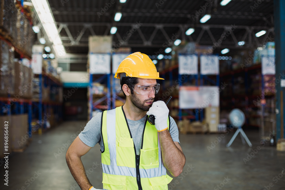 Portrait of caucasian man worker working using walkie-talkie in huge spacious warehouse retail store industry factory. Cargo in ecommerce transport and logistics, Rack of stock storage with carton box Portrait of caucasian man worker working using walkie-talkie in huge spacious warehouse retail store industry factory. Cargo in ecommerce transport and logistics, Rack of stock storage with carton box