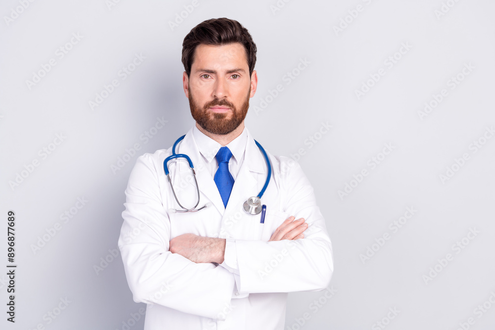 Photo of professional qualified doctor crossed arms empty space wear white coat isolated on grey color background Photo of professional qualified doctor crossed arms empty space wear white coat isolated on grey color background