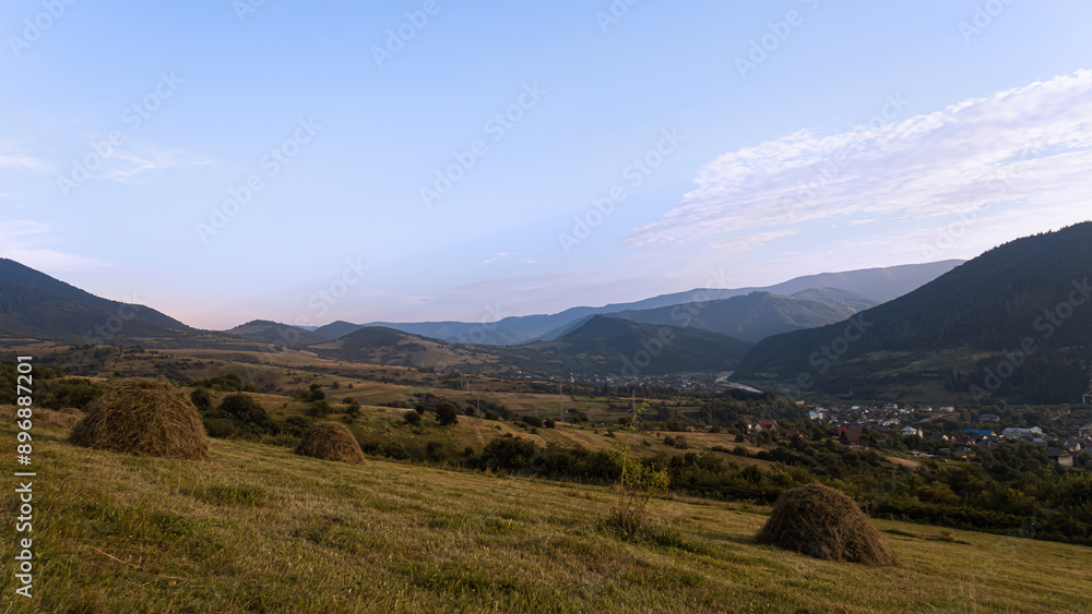 Mountain farmland landscape with haystacks Mountain farmland landscape with haystacks