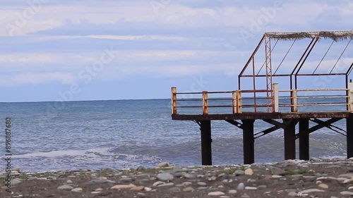 Pier on the shore of the Black Sea in Batumi, Georgia, with sea waves crashing at the coastal area, highlighting the concept of maritime beauty and coastal landscapes.
