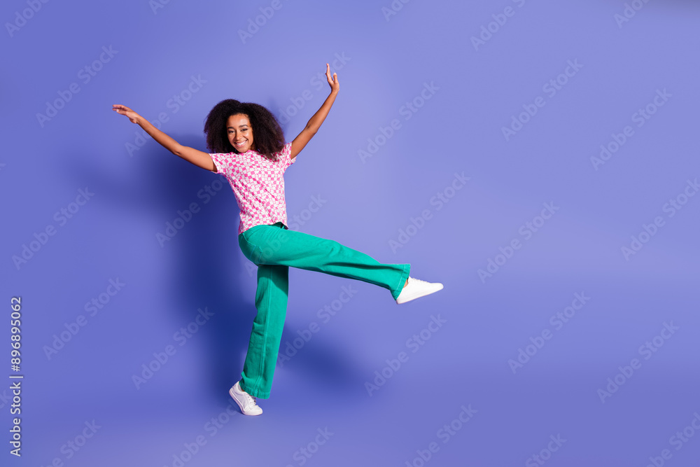 Full size photo of pretty young girl dancing have fun wear trendy pink outfit isolated on purple color background Full size photo of pretty young girl dancing have fun wear trendy pink outfit isolated on purple color background