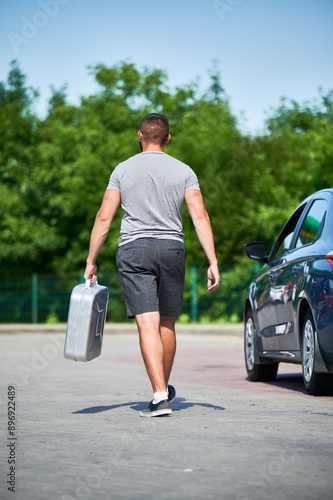 Photography Young man walking along road to nearest gas station to fill canister