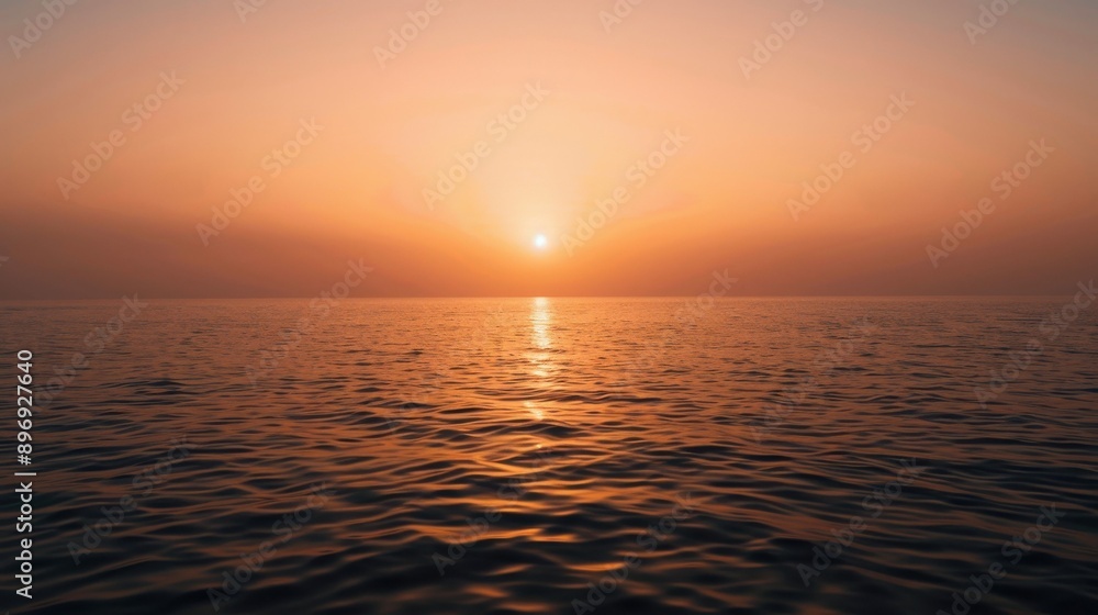 Fototapeta premium Sunset Over Ocean With Gentle Waves And Warm Colors.