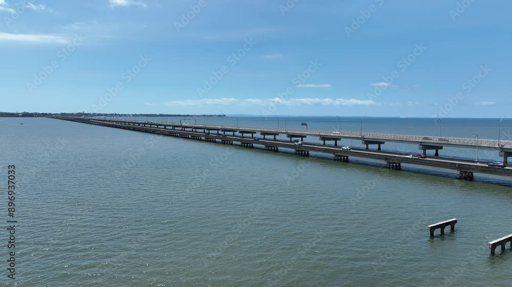 Drone establishing push in shot of Ted Smout Memorial Bridge, side on view of bridge structure with Redcliffe in background. Drone establishing push in shot of Ted Smout Memorial Bridge, side on view of bridge structure with Redcliffe in background.