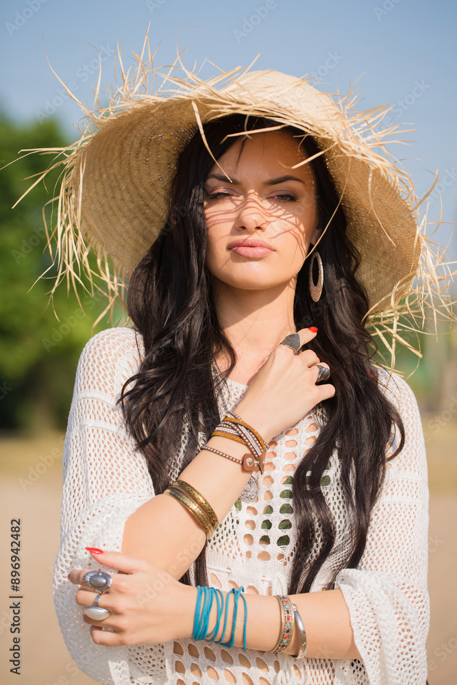 Beautiful woman in a straw hat on the beach. Boho style