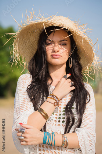 Obraz na płótnie Beautiful woman in a straw hat on the beach. Boho style w salonie