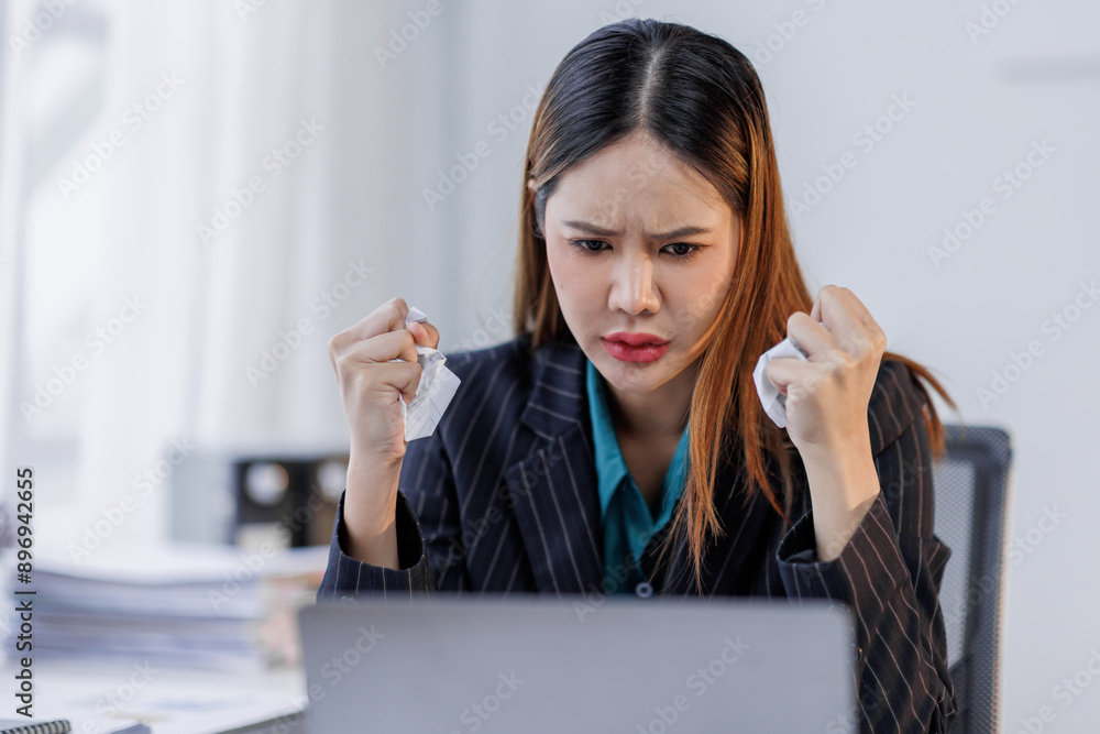 Portrait of tired business asian woman sitting at a work. documents tax laptop computer in office. Sad, unhappy, Worried, Depression, or overworked, failure employee life stress concept Portrait of tired business asian woman sitting at a work. documents tax laptop computer in office. Sad, unhappy, Worried, Depression, or overworked, failure employee life stress concept