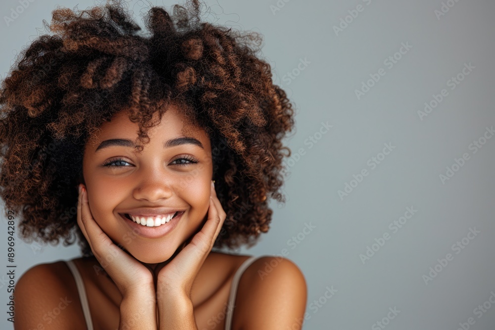 Beautiful african american girl with an afro hairstyle smiling Beautiful african american girl with an afro hairstyle smiling