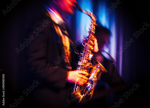 Bild auf Leinwand Abstract motion blurred image of a jazz saxaphonist on stage