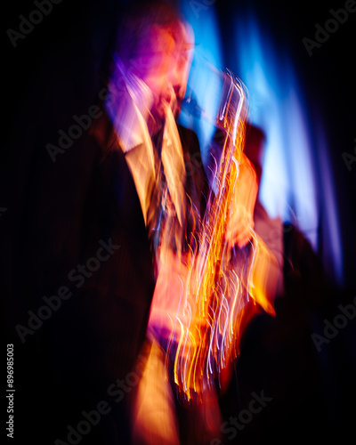 Abstract motion blurred image of a jazz saxaphonist on stage